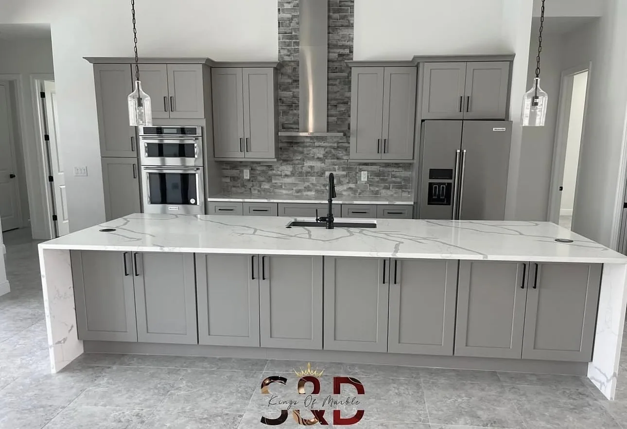 Full kitchen with quartz island and gray cabinets